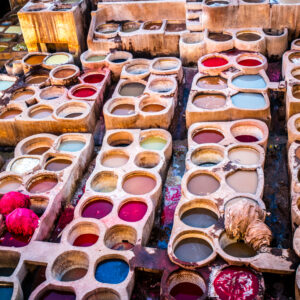 Dye is contained in a large jar, and it is dyed leather.